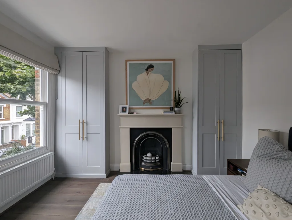 custom wardrobes next to a fire place London - built in wardrobes