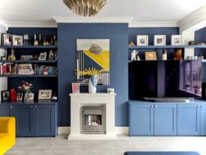 floating shelves either side of a fireplace with built in cabinets and TV stand