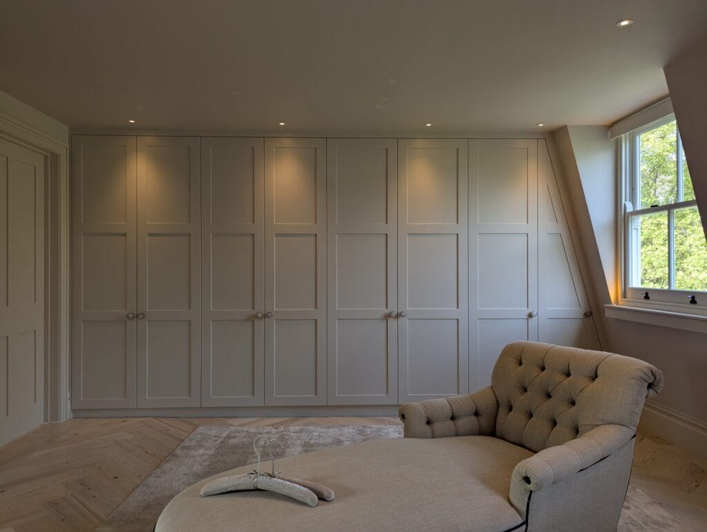 Custom built in loft wardrobes across a large living room
