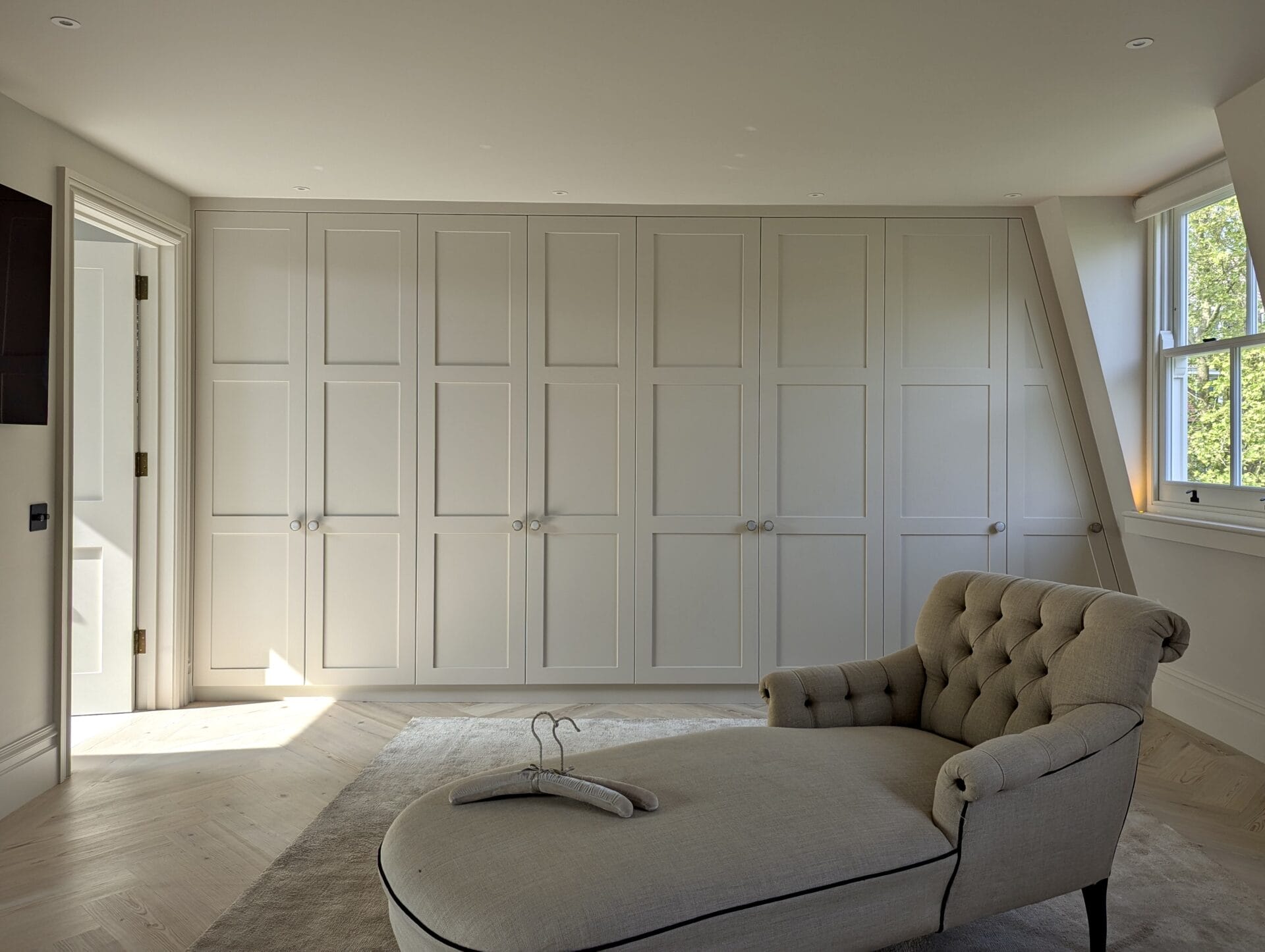 bespoke loft wardrobes across the wall
